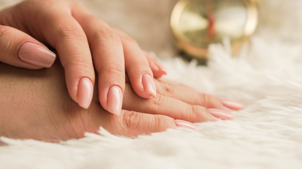 persons hand on white textile